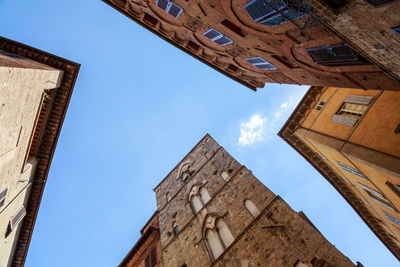 Low angle view of old building against clear blue sky