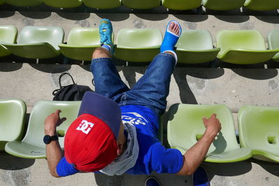 High angle view of man sitting on seat