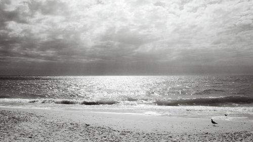 Scenic view of sea against cloudy sky