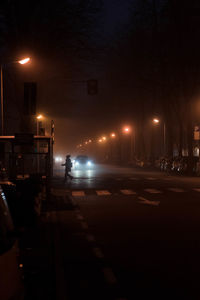 Illuminated city street at night