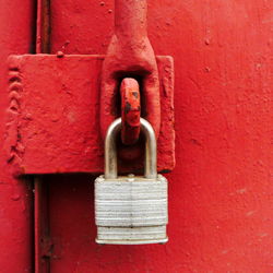 Close-up of padlock on red door