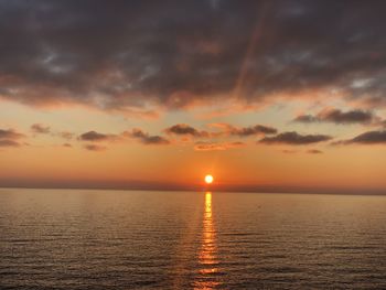 Scenic view of sea against romantic sky at sunset