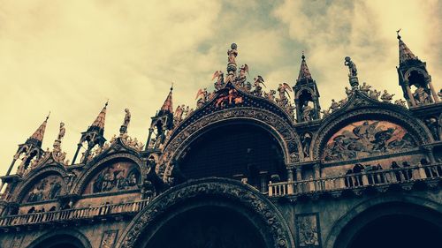 Low angle view of cathedral against cloudy sky