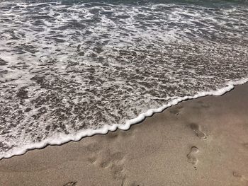 High angle view of surf on beach
