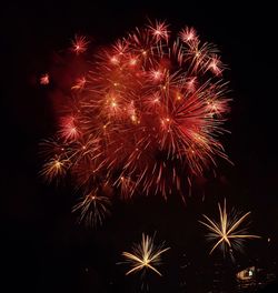 Low angle view of firework display at night