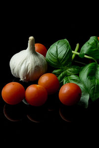 Close-up of tomatoes against black background