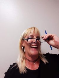 Portrait of smiling mature woman against white background