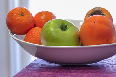 Close-up of fruits in bowl on table