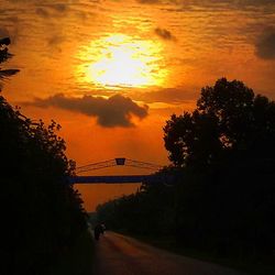 Cars on road at sunset