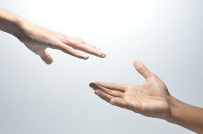 Close-up of hands over white background