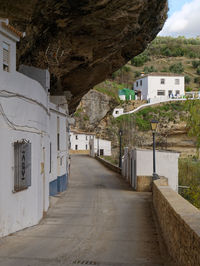 Footpath amidst buildings in city