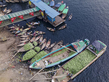 People unloading watermelons at old dhaka river port along buriganga river in dhaka, bangladesh.