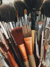Close-up of paintbrushes in container