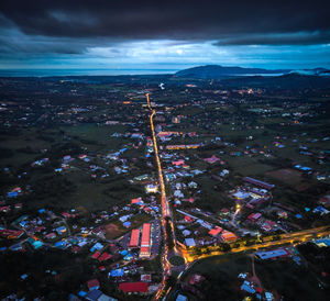 High angle view of illuminated city against sky at night