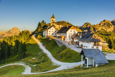 Mount lussari. fiery sunset over the sanctuary and the julian alps. italy