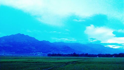 Scenic view of landscape against cloudy sky