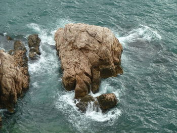 High angle view of rocks in sea