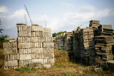 Stack of stone structure on field against sky