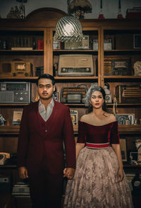 Portrait of young woman standing at home