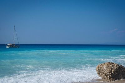 Scenic view of sea against clear blue sky