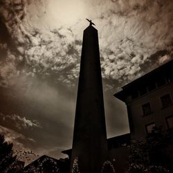 Low angle view of building against cloudy sky