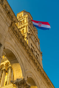 Diocletian's palace in split. croatian flag waving in the wind.