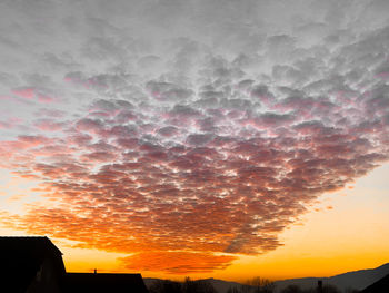 Silhouette buildings against sky during sunset