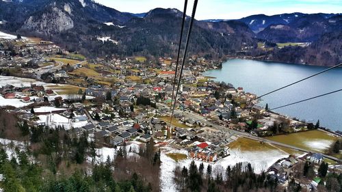 High angle view of town and lake against mountain