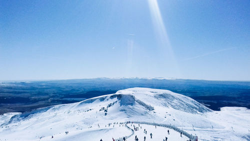 Scenic view of snowcapped mountains against clear blue sky