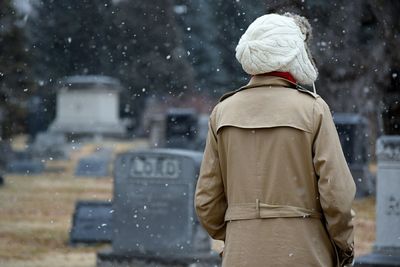 Rear view of a woman at cemetery