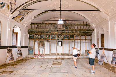 Rear view of people walking in building