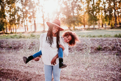 Full length of smiling woman on land