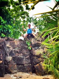 Man standing by tree