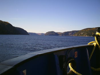 Boats in sea against clear sky