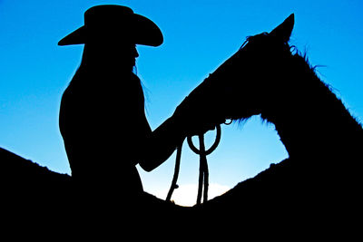 Low angle view of silhouette man against clear sky