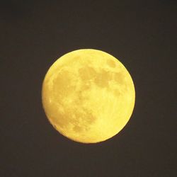 Low angle view of moon in dark sky