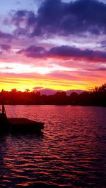 Scenic view of sea against dramatic sky during sunset