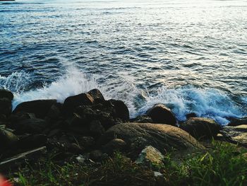 High angle view of waves splashing on rocks