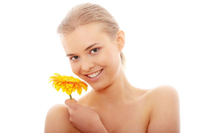 Portrait of smiling young woman against white background