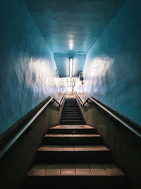 Staircase in illuminated tunnel