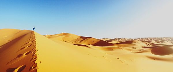 Scenic view of desert against blue sky