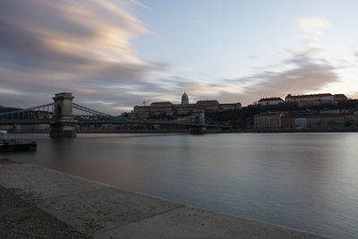 Bridge over river with city in background