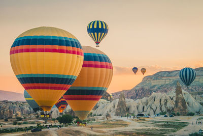 Multi colored hot air balloons flying over land