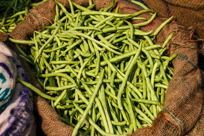 Close-up of green beans for sale in sack