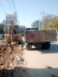 Construction site by road against sky