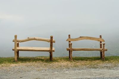 Chair on wooden structure against sky