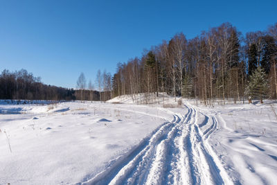 Snow covered field against sky