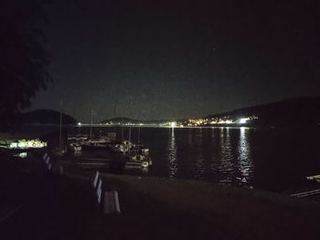 Scenic view of lake against sky at night