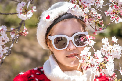 Close-up portrait of a girl with pink flowers