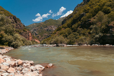 Scenic view of lake and mountains against sky